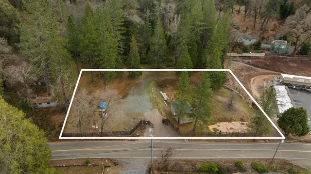 a view of backyard with barn and large trees
