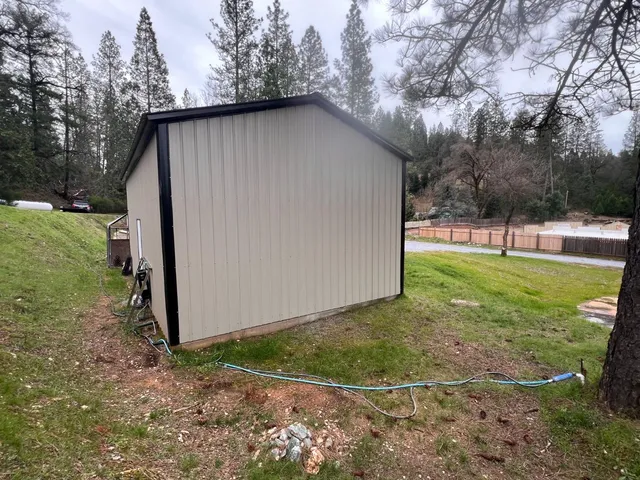 a front view of a house with a yard and trees