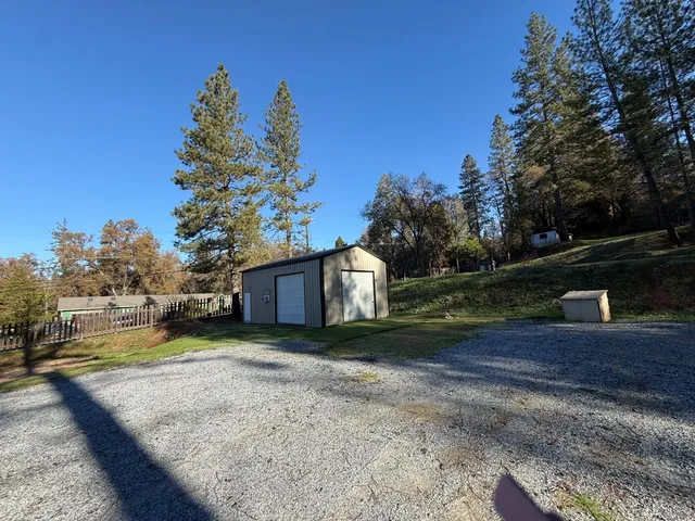 a view of a house with a yard and covered with snow in the background