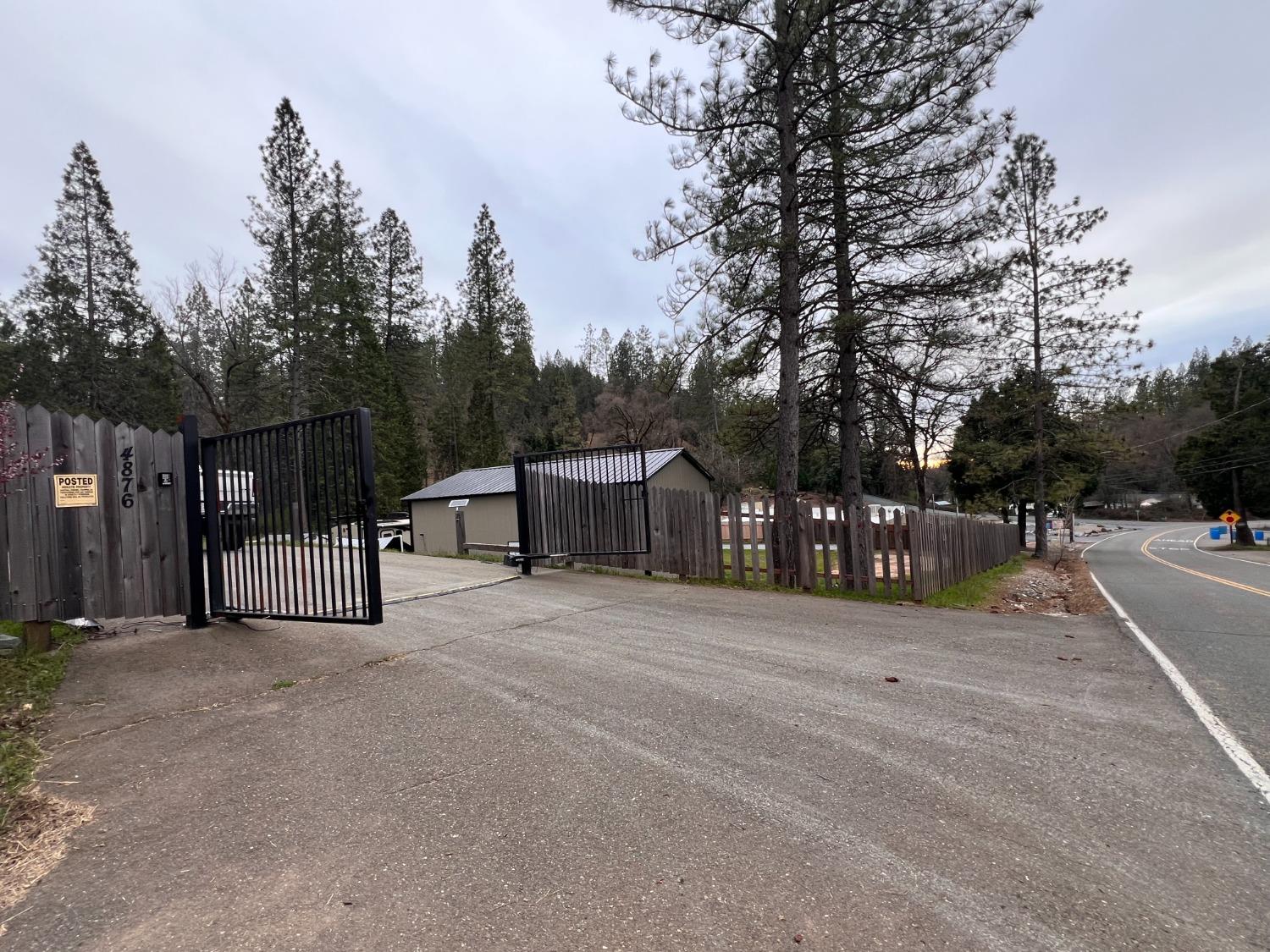 4876 Black Oak Mine Road Garden Valley, CA 95633 - Photo 8 of 31 a front view of a house with a yard and trees