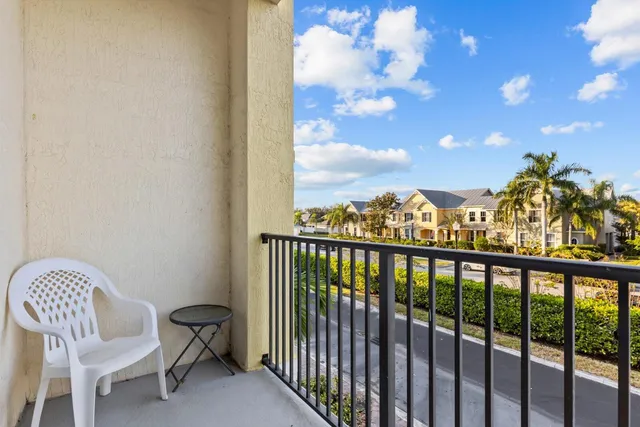 a view of a balcony with chair and city view