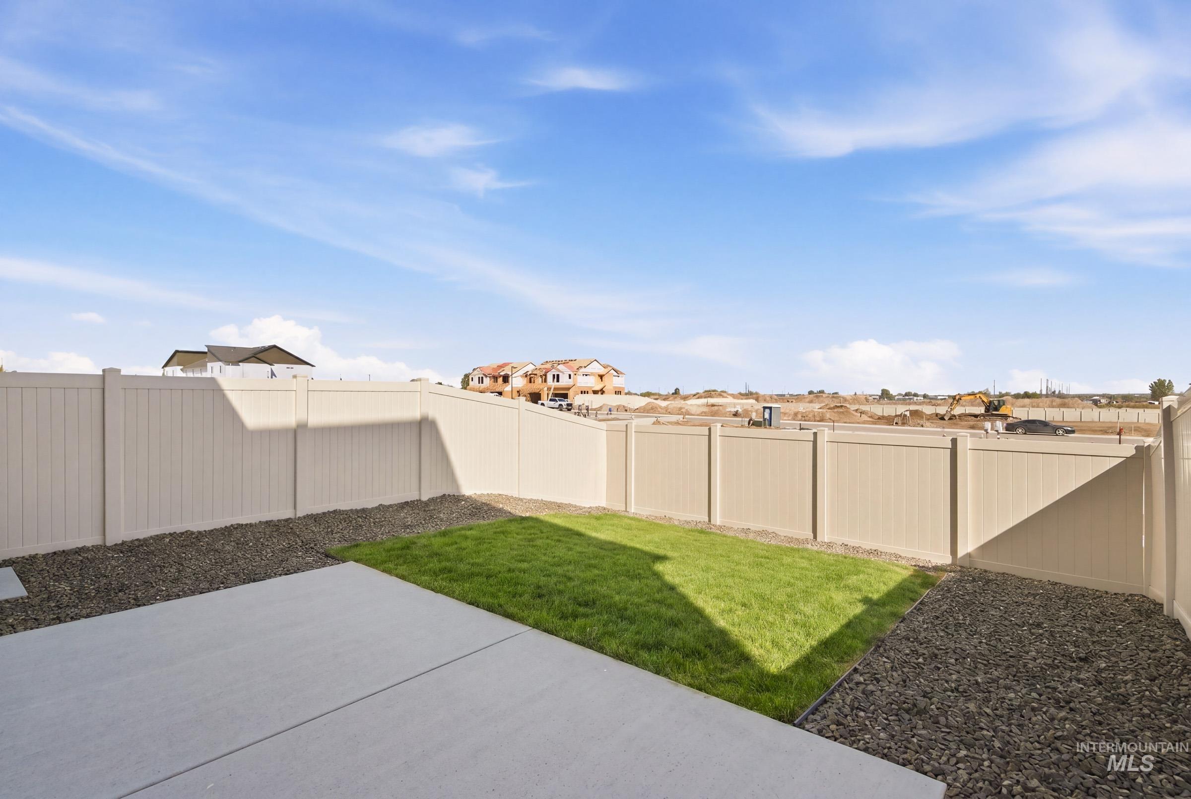 10800 Rutland Street Caldwell, ID 83605 - Photo 21 of 21 Private backyard featuring a concrete patio, a patch of green lawn, and gravel landscaping