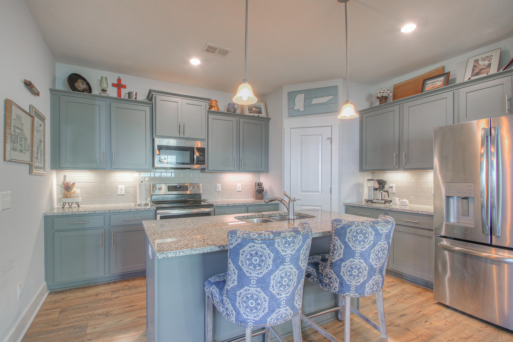 5042 Gracious Drive Franklin, TN 37064 - Photo 3 of 14 a kitchen with granite countertop stainless steel appliances a refrigerator a sink a stove a microwave and dining table