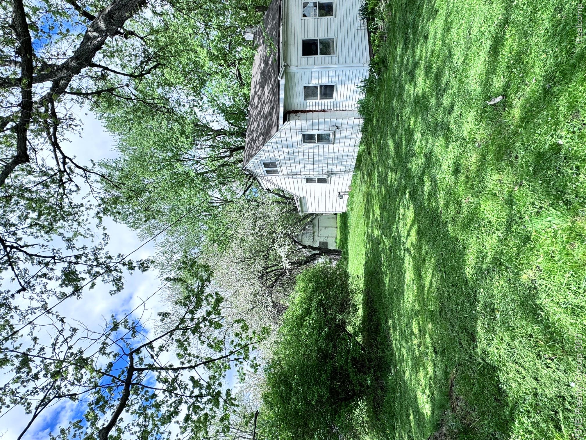 4928 Hughes Road Lansing, MI 48910 - Photo 33 of 35 Expansive green lawn with mature trees providing shade