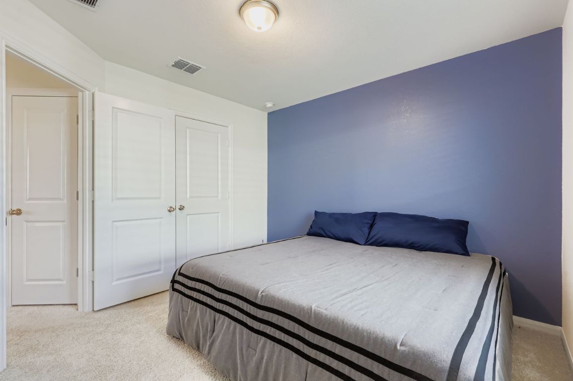 157 LT Rusty Drive Jarrell, TX 76537 - Photo 24 of 26 a bedroom with a bed and a cabinets