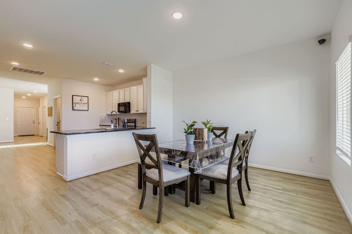 157 LT Rusty Drive Jarrell, TX 76537 - Photo 10 of 26 a view of a dining room with furniture and wooden floor