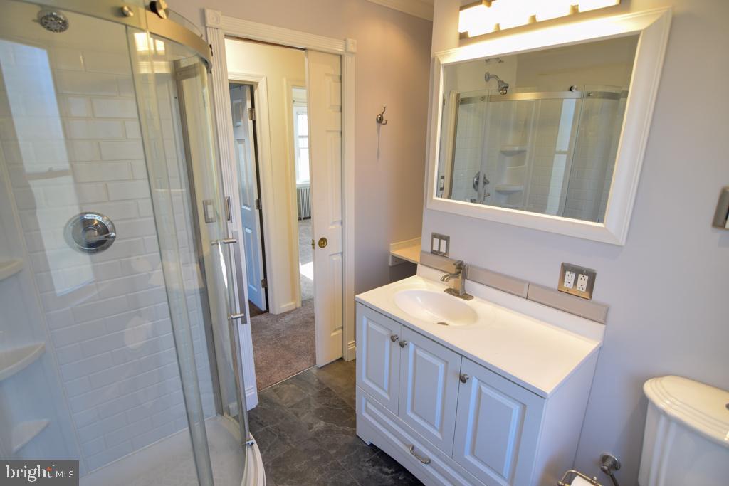 1071 West Bristol Road Warminster, PA 18974 - Photo 18 of 34 a bathroom with a sink a mirror a vanity and a shower