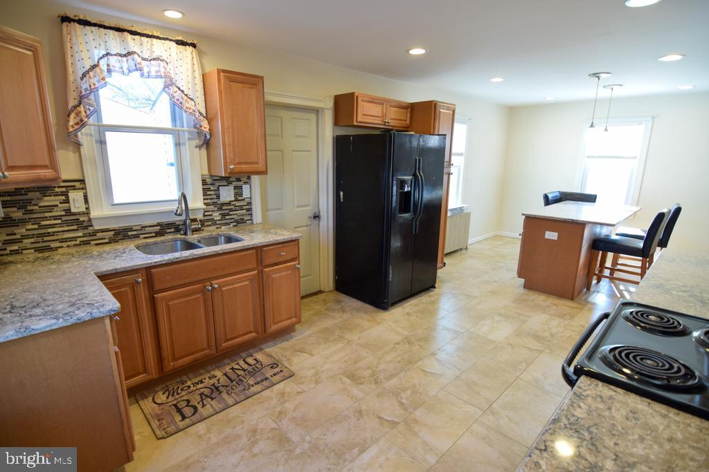 1071 West Bristol Road Warminster, PA 18974 - Photo 5 of 34 a kitchen with stainless steel appliances granite countertop a refrigerator and a sink