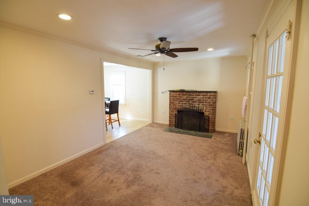 1071 West Bristol Road Warminster, PA 18974 - Photo 9 of 34 a view of a livingroom with a fireplace and a ceiling fan