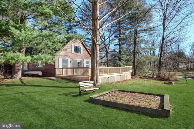 a living room with furniture and a dining table with wooden floor