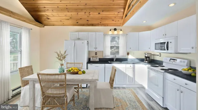 a view of a kitchen with microwave and cabinets