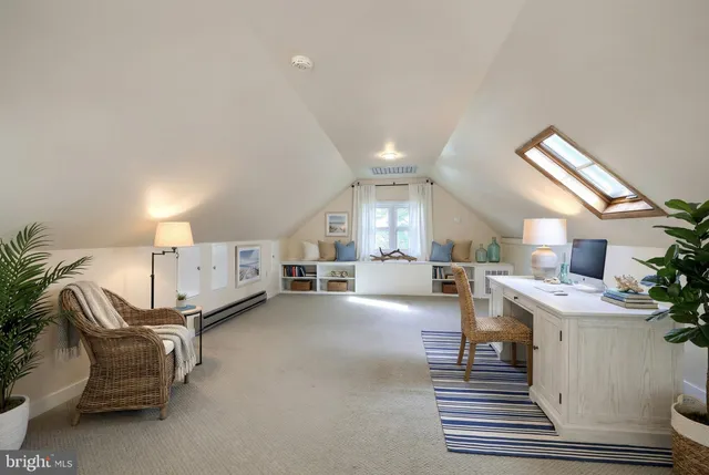 an aerial view of ocean and residential houses with outdoor space