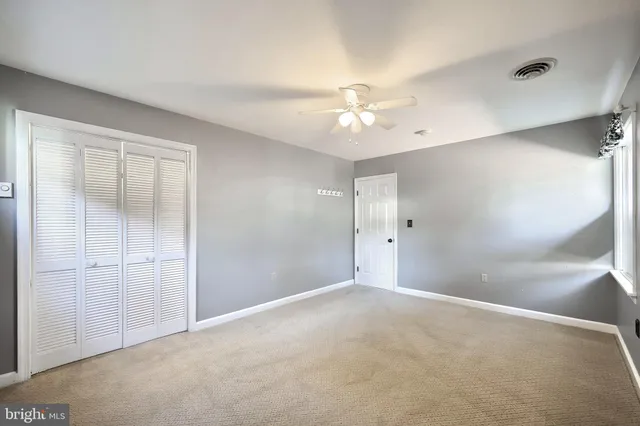 a view of swimming pool with lounge chair and dinning table under an umbrella