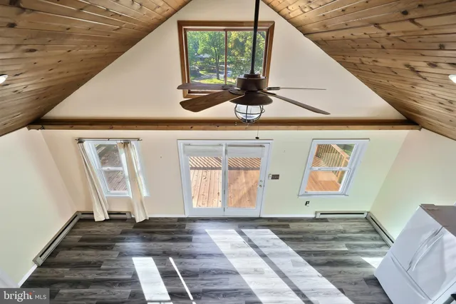 a view of pool with table and chairs under an umbrella