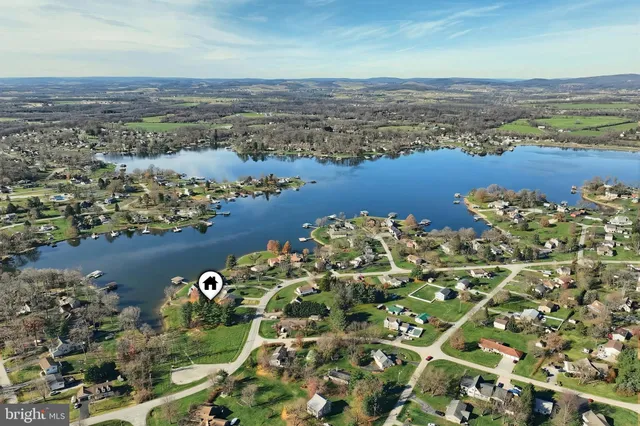 an aerial view of residential houses with outdoor space and river