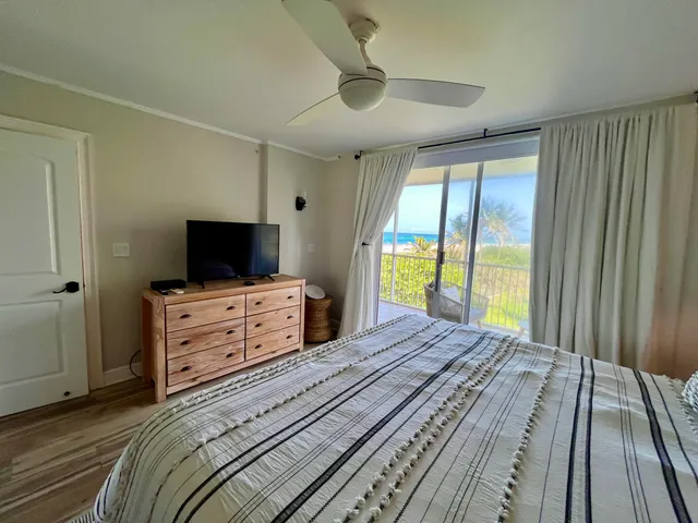 a bedroom with a bed and a flat tv screen