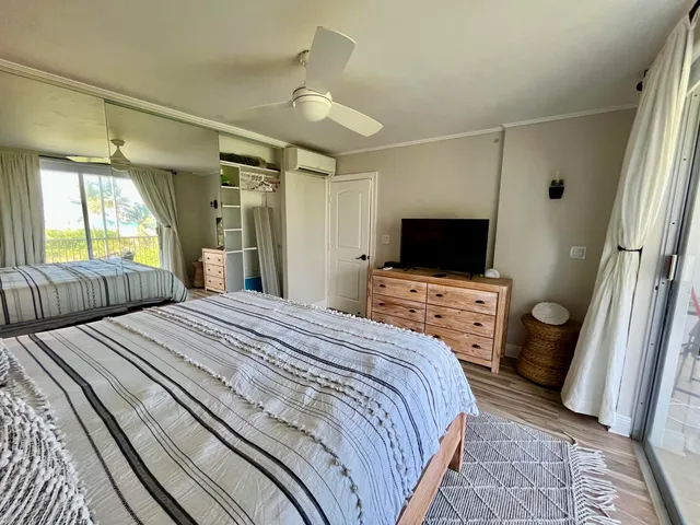 a bedroom with a bed and a flat screen tv