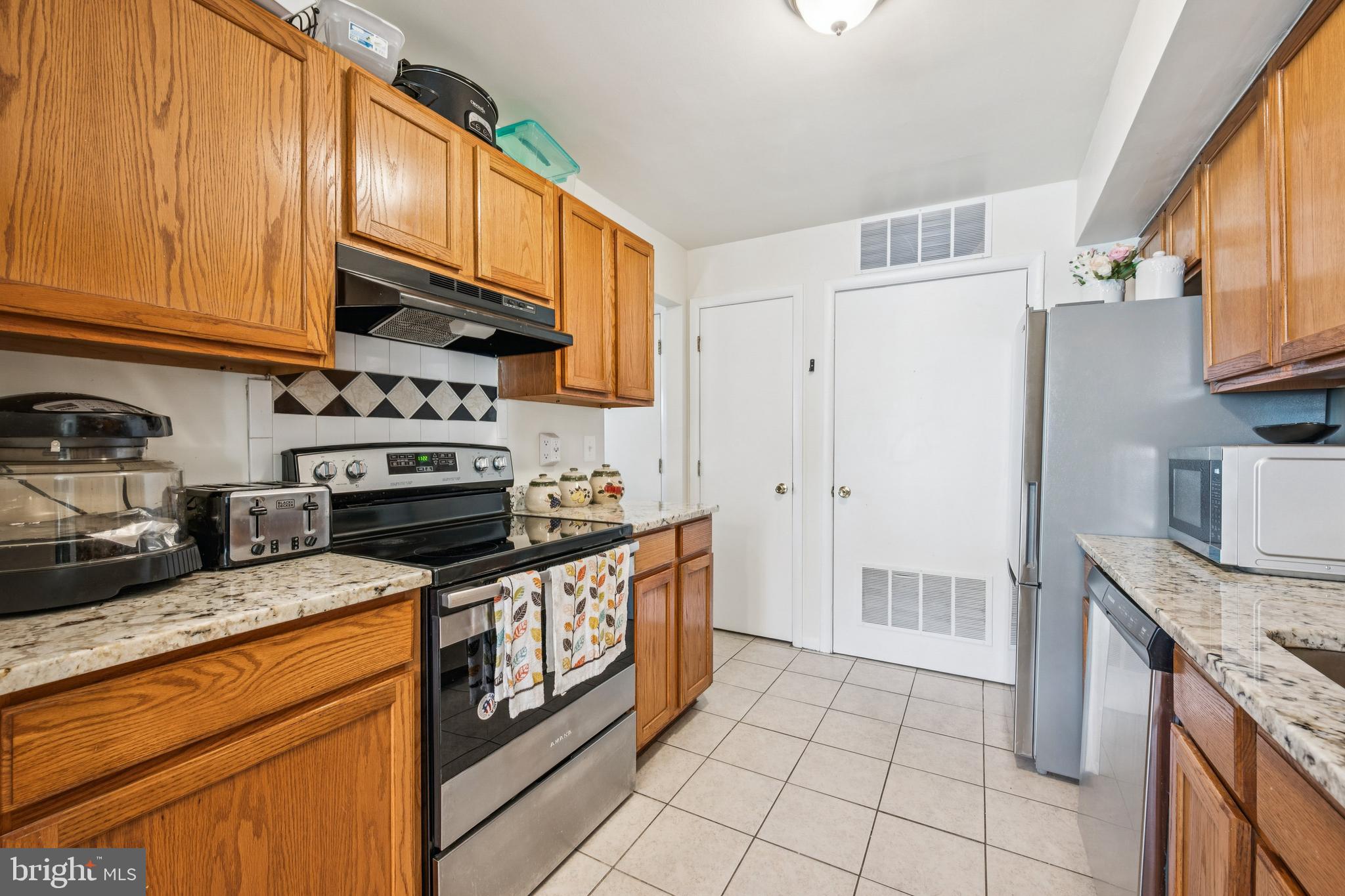 7 Lennox Court Sicklerville, NJ 08081 - Photo 14 of 25 a kitchen with stainless steel appliances granite countertop a stove a sink and a refrigerator