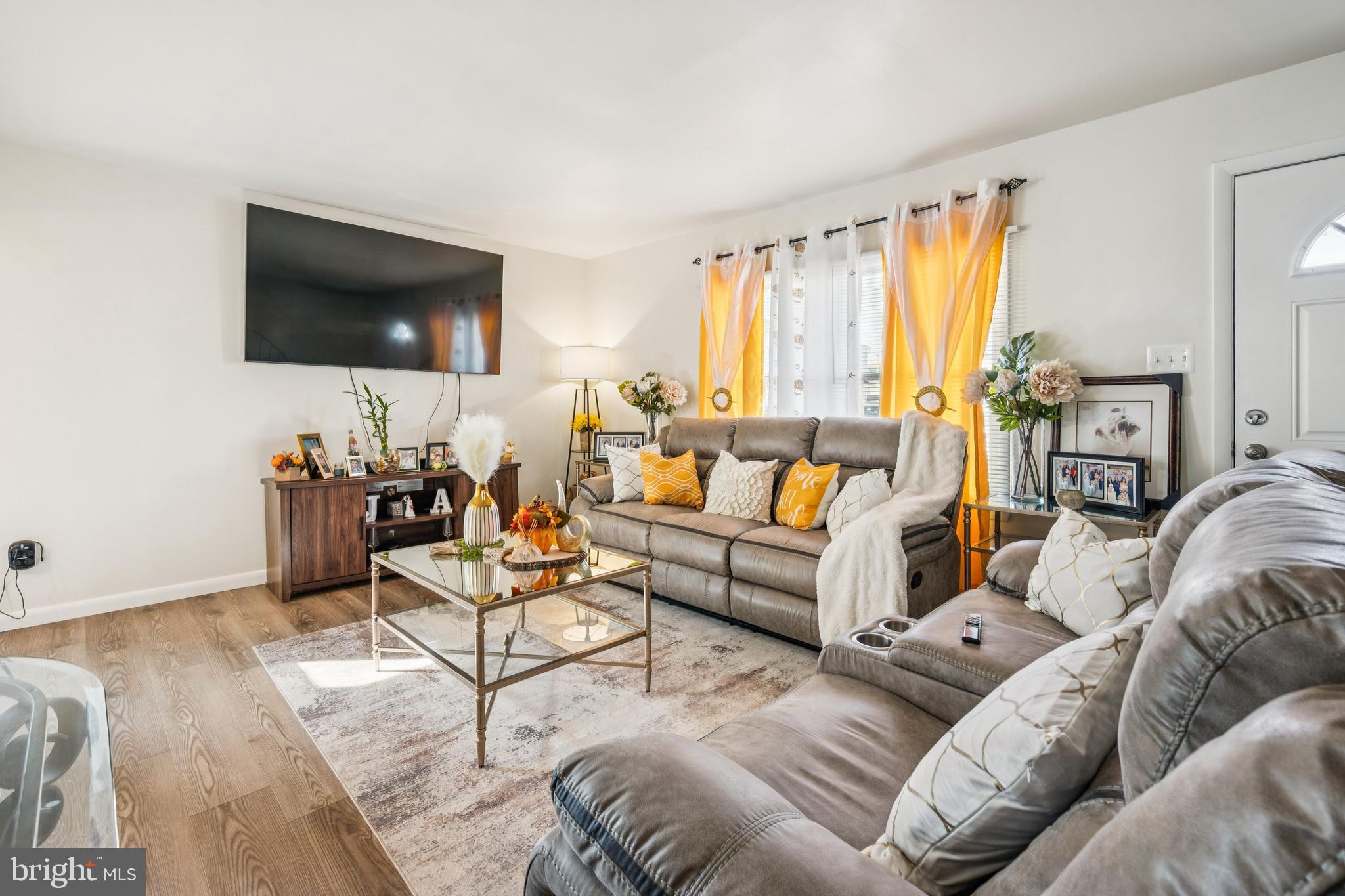 7 Lennox Court Sicklerville, NJ 08081 - Photo 8 of 25 a living room with furniture a flat screen tv and a large window