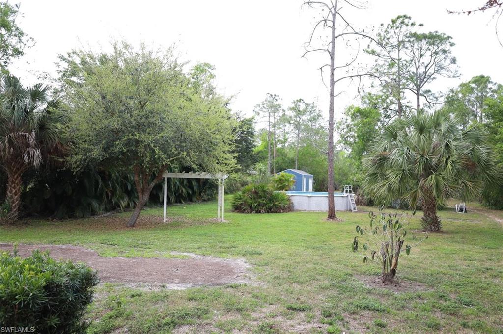 4295 14th Street Northeast Naples, FL 34120 - Photo 22 of 23 View of green lawn with an outdoor pool