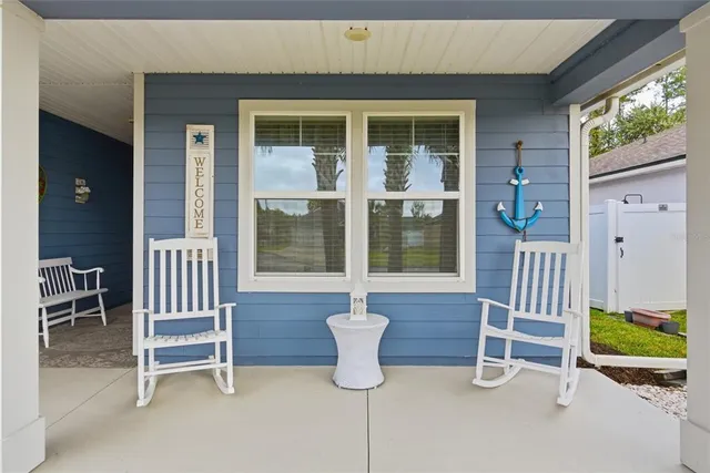 a view of two chairs in the patio with a small yard