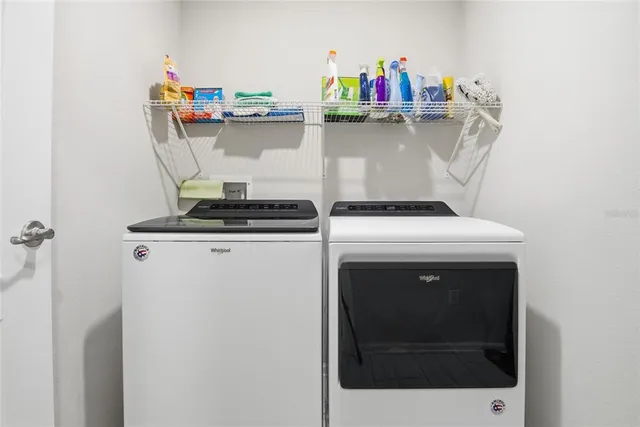 a bedroom with furniture and a large window