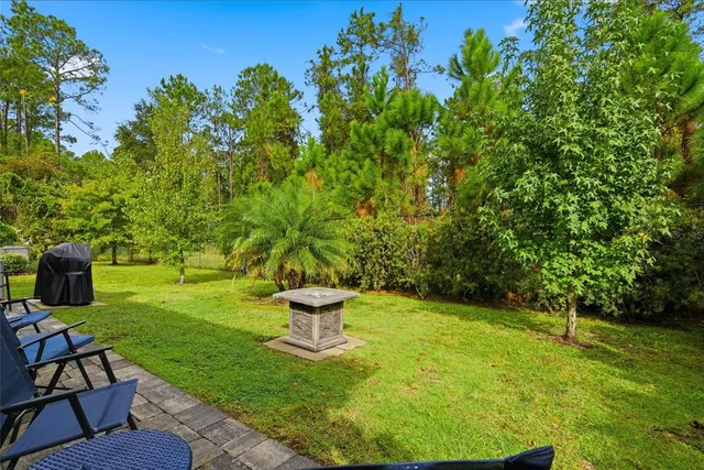 a view of a chair and tables in the patio and a couple of chairs in patio