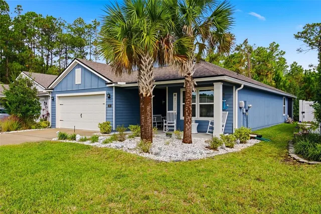 a view of an house with backyard space and garden