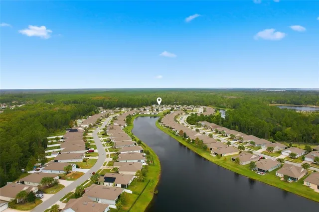 a view of a city with lots of residential buildings ocean and mountain view