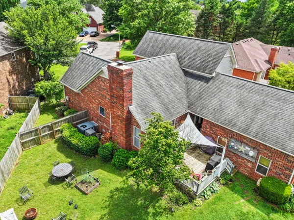 an aerial view of a house with garden space and street view