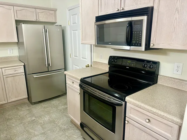 a kitchen with refrigerator and microwave