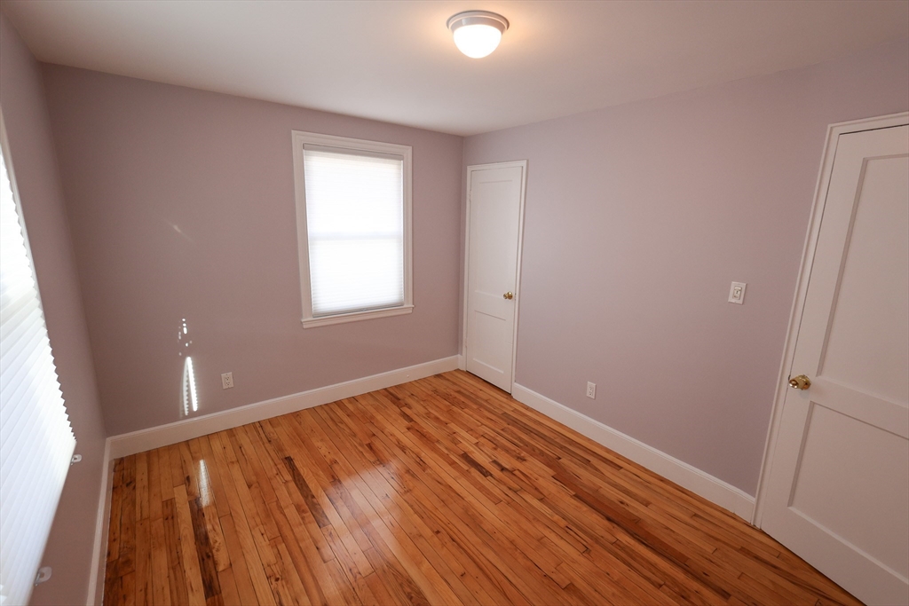 33 Paragon Road, Unit 1 Boston, MA 02132 - Photo 19 of 20 a view of an empty room with wooden floor and a window