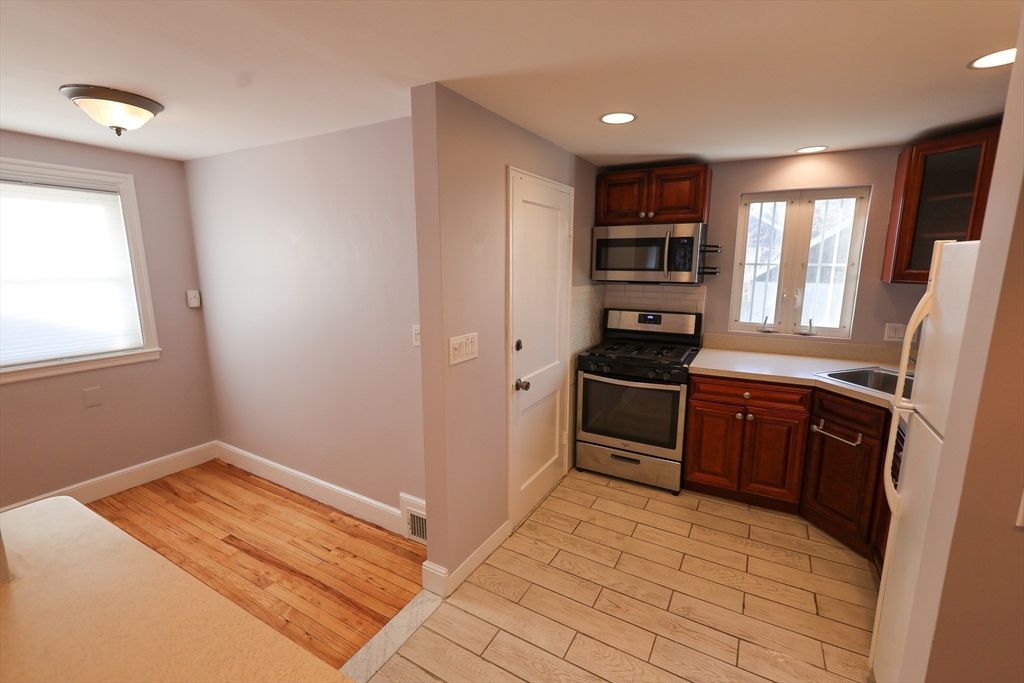 33 Paragon Road, Unit 1 Boston, MA 02132 - Photo 4 of 20 a kitchen with a refrigerator stove and oven
