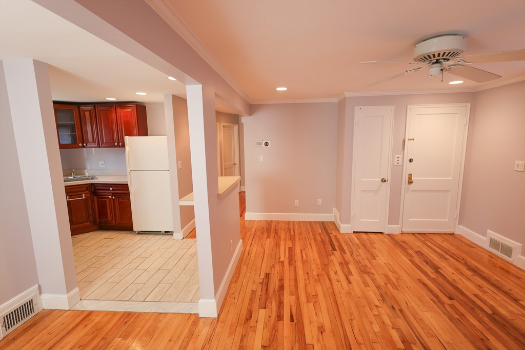33 Paragon Road, Unit 1 Boston, MA 02132 - Photo 7 of 20 a view of a kitchen with a sink and wooden floor