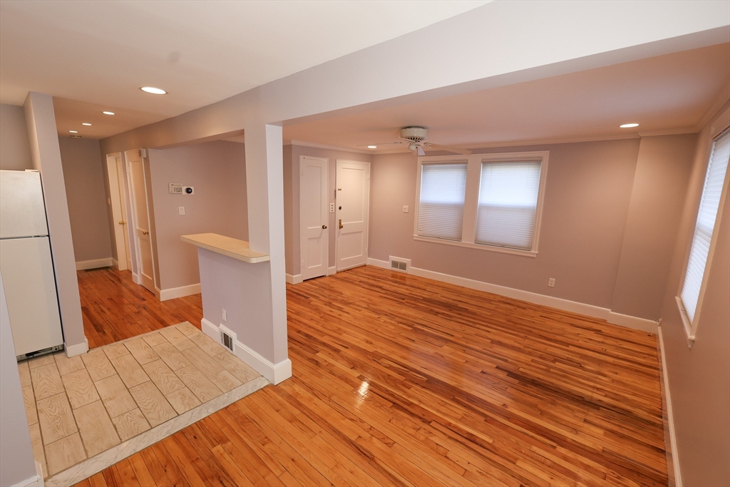 33 Paragon Road, Unit 1 Boston, MA 02132 - Photo 9 of 20 a bedroom with a bed and a large window