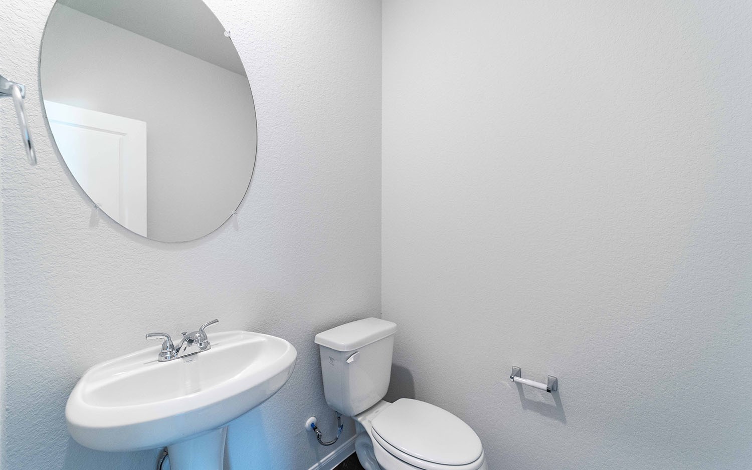 4315 Maple Root Lane Pinehurst, TX 77362 - Photo 18 of 27 a white toilet sitting next to a bathroom sink