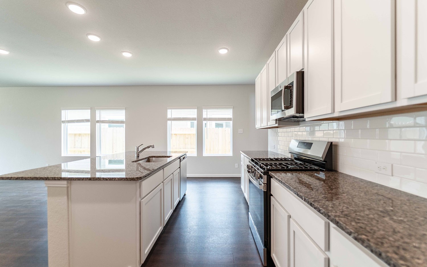 4315 Maple Root Lane Pinehurst, TX 77362 - Photo 2 of 27 a kitchen with granite countertop a sink a counter space appliances and cabinets