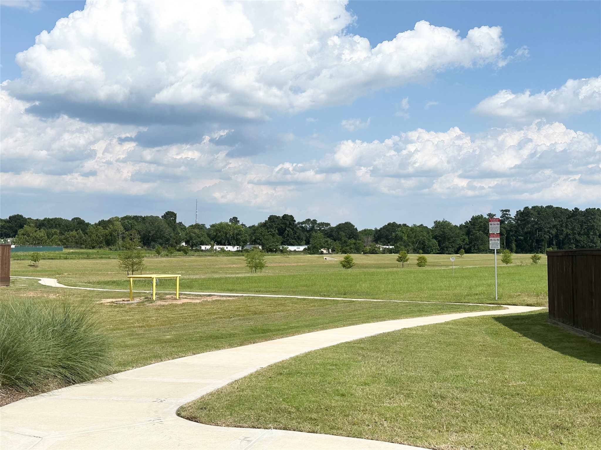 4315 Maple Root Lane Pinehurst, TX 77362 - Photo 22 of 27 a view of a lake with a houses in the background