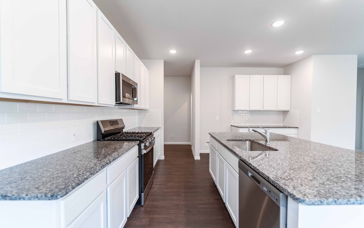 4315 Maple Root Lane Pinehurst, TX 77362 - Photo 5 of 27 a kitchen with stainless steel appliances granite countertop a sink stove and cabinets