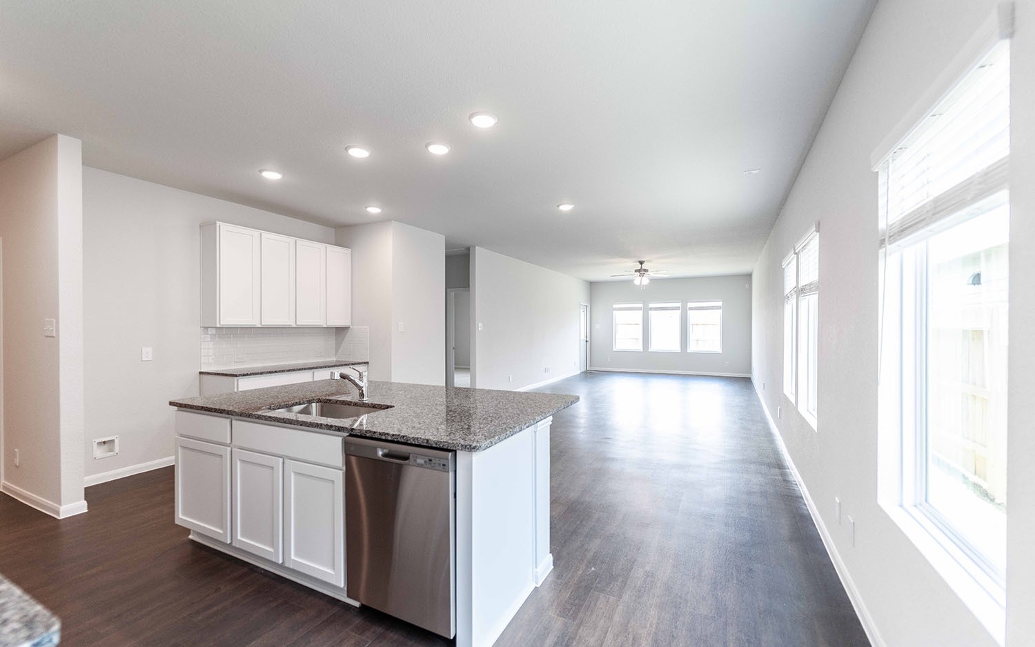 4315 Maple Root Lane Pinehurst, TX 77362 - Photo 7 of 27 a kitchen with a stove and white cabinets