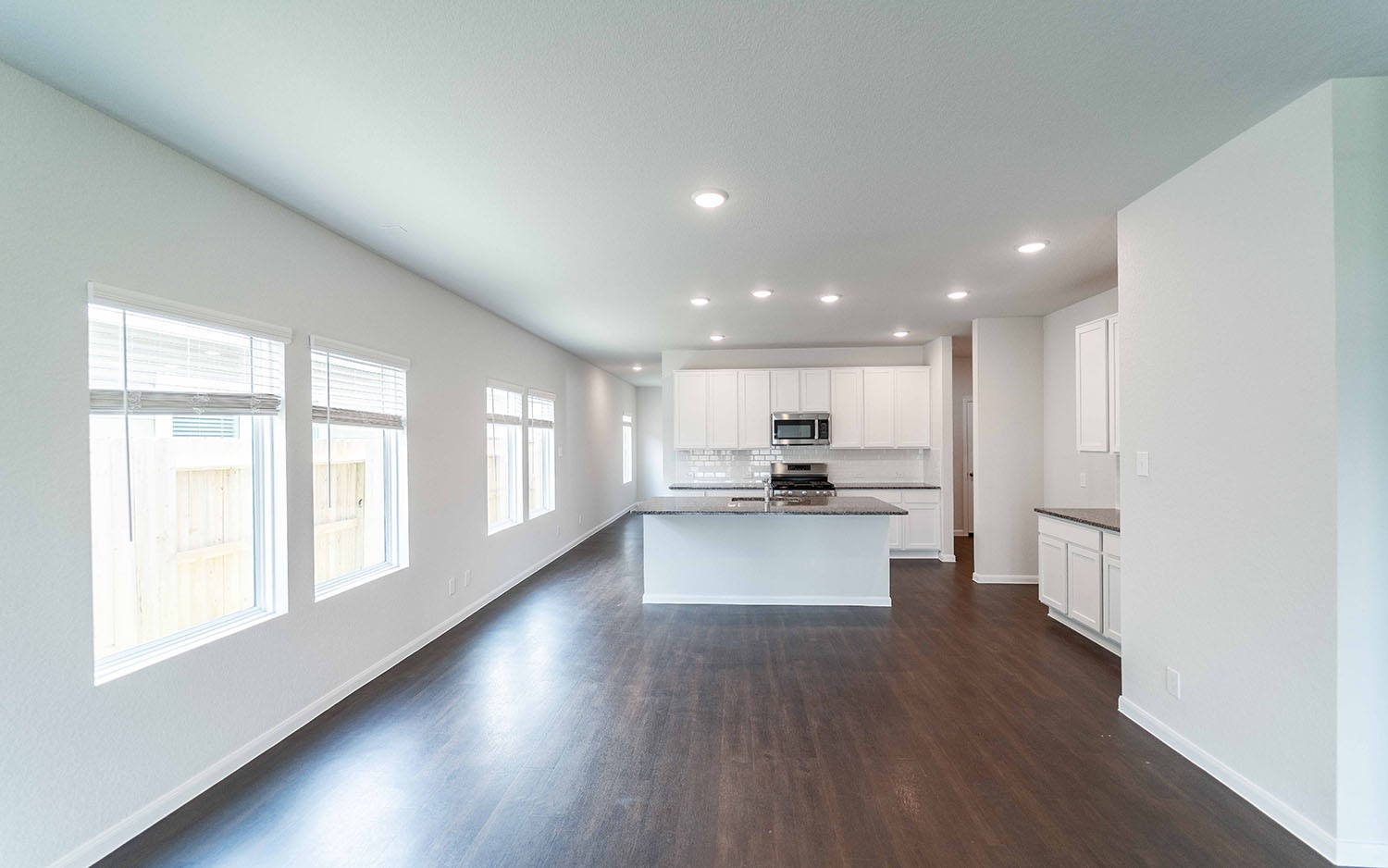 4315 Maple Root Lane Pinehurst, TX 77362 - Photo 9 of 27 a kitchen with a sink and wooden floor