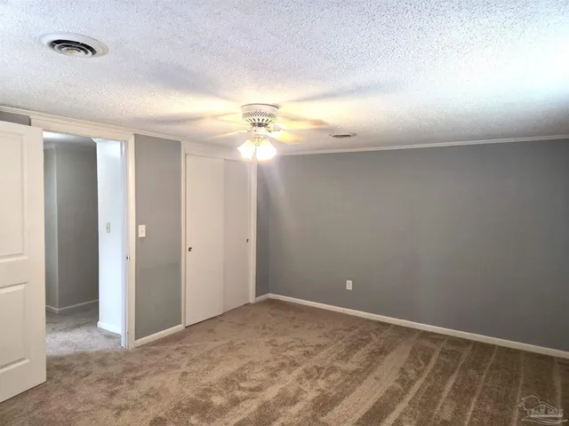 a view of a livingroom with a ceiling fan and window
