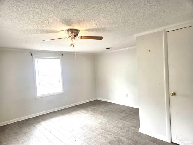 a view of entryway with bedroom and window