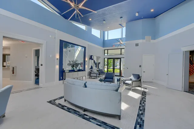 a living room with furniture gym equipment and a large window