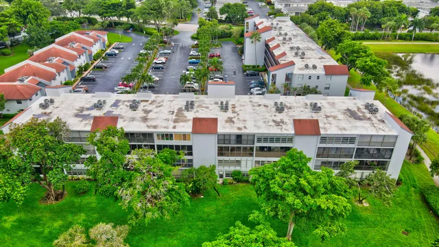 an aerial view of multiple houses with yard