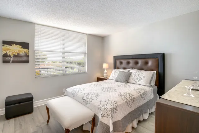 a bedroom with a bed and a chair