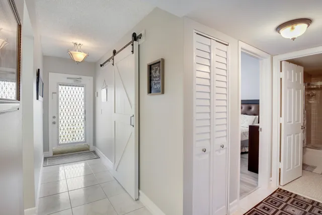 a view of a hallway with wooden shelves