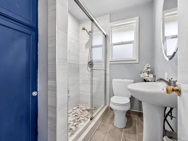 a bathroom with a sink toilet and shower