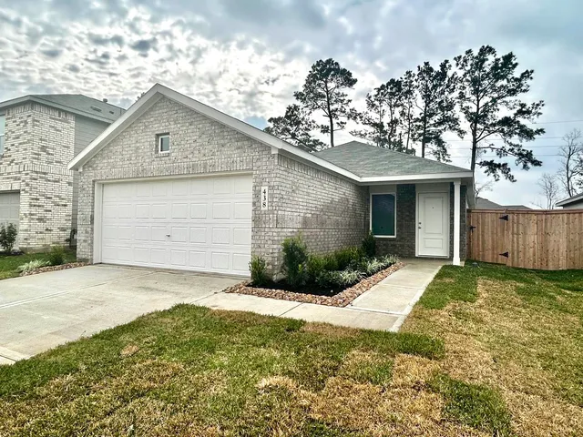 a view of a house with a yard and garage