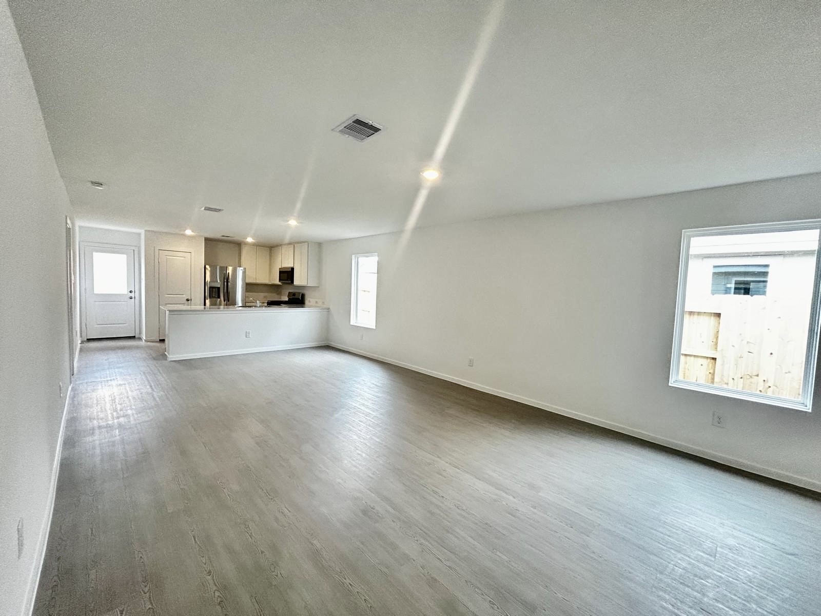 438 Southern Magnolia Way Magnolia, TX 77354 - Photo 2 of 18 wooden floor in an empty room with a window